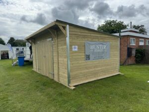 12ft x 18ft pent roof timber workshop with double wooden doors, ideal for storage, hobbies and workspace use.
