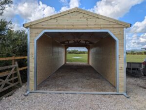 Premium 12 x 36 walk through field shelter providing spacious weather protection for horses, livestock, and equestrian facilities.