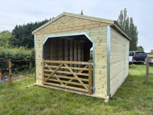 12ft x 18ft timber walk through horse field shelter with galvanised steel frame and timber gates, suitable for paddocks and equestrian use.