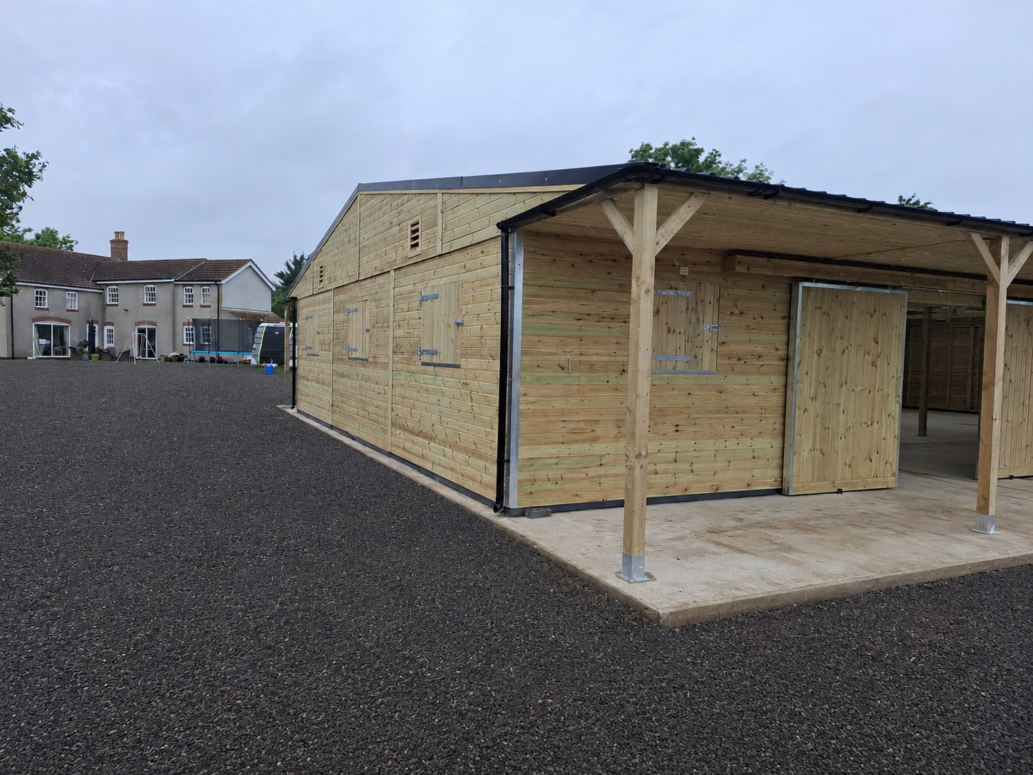 Bespoke 36x60 timber American barn with open bays and covered overhangs