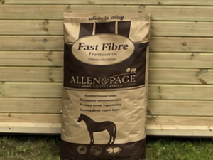 Fast fibre leaning against a timber stable building
