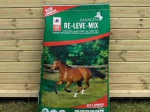 Saracen Re-Leve- Mix 20kg bag leaning against a timber stable building