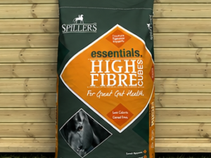 Spillers High Fibre 20kg bag leaning against a timber stable building