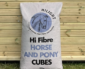 HiLight Hi Fibre Horse and Pony Cubes feed leaning against a timber stable building