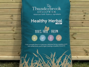 Thunderbrook Healthy Herbal Chaff bag leaning against a timber stable building