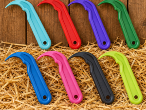 Red Gorilla Hoof Picks in 8 colours on a rustic stable background
