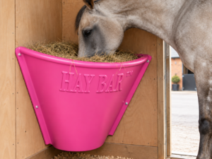 HayBar Classic Horse Pink hay feeder in wooden stable